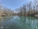 Scenic view of a tranquil pond reflecting the surrounding trees under a clear blue sky at 8460 S Green Dr, Nineveh, IN 46164