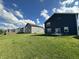 Expansive backyard with lush green grass and neighboring homes in a quiet community at 8626 Jeff Cir, Brownsburg, IN 46112
