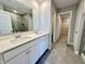Bathroom featuring a double vanity with a large mirror and stone countertop and view to the shower at 8626 Jeff Cir, Brownsburg, IN 46112