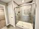 Bathroom featuring a shower with glass doors and tile walls at 8626 Jeff Cir, Brownsburg, IN 46112