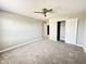 Bedroom featuring carpet, ceiling fan, neutral walls, closet, and view to hallway at 8626 Jeff Cir, Brownsburg, IN 46112