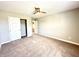 Bedroom featuring carpet, ceiling fan, neutral walls, closet, and view to hallway at 8626 Jeff Cir, Brownsburg, IN 46112