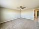 Bedroom featuring carpet, ceiling fan, neutral walls, and view to hallway at 8626 Jeff Cir, Brownsburg, IN 46112
