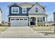 Inviting two-story home with a modern blue and white exterior and a two-car garage at 8626 Jeff Cir, Brownsburg, IN 46112
