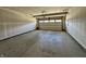 Unfinished two-car garage showing concrete floor and garage door at 8626 Jeff Cir, Brownsburg, IN 46112