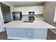 Modern kitchen boasts a large island, stainless steel appliances, and ample cabinet storage space at 8626 Jeff Cir, Brownsburg, IN 46112