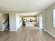 Open-concept living space with hardwood floors, a modern kitchen, and bright natural light at 8626 Jeff Cir, Brownsburg, IN 46112