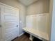 Mudroom entrance featuring bench with coat rack above, and a door at 8626 Jeff Cir, Brownsburg, IN 46112