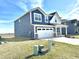 Side view of a modern two-story home with a well-kept lawn and a two-car garage at 8626 Jeff Cir, Brownsburg, IN 46112