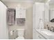 Bathroom featuring white cabinets, marble vanity, and tile backsplash at 8715 Legion Ln, Indianapolis, IN 46231