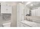 Bathroom featuring white cabinets, marble vanity, and tile backsplash at 8715 Legion Ln, Indianapolis, IN 46231
