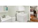 Laundry room featuring a sink, washer, dryer, white cabinets, and green walls at 8715 Legion Ln, Indianapolis, IN 46231