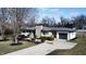 Aerial view of the residence exhibits a large driveway and lush front lawn at 8795 Carrollton Ave, Indianapolis, IN 46240
