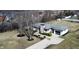 Single-story home with a stone chimney, an attached garage, and a charming, landscaped front yard at 8795 Carrollton Ave, Indianapolis, IN 46240