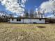 The back of the house features a simplistic design and a spacious lawn at 8795 Carrollton Ave, Indianapolis, IN 46240