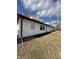 The side of the house shows off its freshly landscaped beds at 8795 Carrollton Ave, Indianapolis, IN 46240