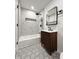 Modern bathroom featuring hexagon tiles, a stylish vanity, and sleek black fixtures for a contemporary design at 8795 Carrollton Ave, Indianapolis, IN 46240