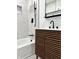 Close-up of a renovated bathroom with a wood vanity cabinet and matte black faucet at 8795 Carrollton Ave, Indianapolis, IN 46240