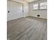 Bedroom featuring grey wood floors, fresh white walls, closet and windows at 8795 Carrollton Ave, Indianapolis, IN 46240