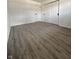 Bedroom featuring grey wood floors, fresh white walls, two closets and a window at 8795 Carrollton Ave, Indianapolis, IN 46240