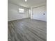 Bright bedroom features gray-toned flooring, closet space, and natural light at 8795 Carrollton Ave, Indianapolis, IN 46240