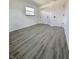Bedroom featuring grey wood floors, fresh white walls, closet and windows at 8795 Carrollton Ave, Indianapolis, IN 46240