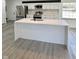 Bright, modern kitchen featuring a large island with a sink, stainless steel appliances, and stylish gray flooring at 8795 Carrollton Ave, Indianapolis, IN 46240