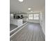 Bright living area with gray-toned flooring, recessed lighting, and open access to kitchen at 8795 Carrollton Ave, Indianapolis, IN 46240