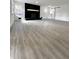 Spacious living room with gray-toned flooring, fireplace, and access to the front door at 8795 Carrollton Ave, Indianapolis, IN 46240