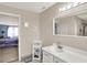 Well-lit bathroom with a white vanity, mirror, and view into an adjacent bedroom at 9243 Crossing Dr, Fishers, IN 46037