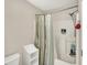 Neutral bath includes storage space, showerhead and curtain in front of the tub and shower area at 9243 Crossing Dr, Fishers, IN 46037