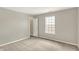 Bright bedroom with a window and open door features neutral walls and carpet at 9243 Crossing Dr, Fishers, IN 46037