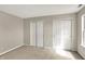 Bedroom with sliding closet doors and a window offering natural light and neighborhood views at 9243 Crossing Dr, Fishers, IN 46037