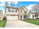 Charming two-story home with a well-manicured lawn, attached two-car garage, and inviting curb appeal at 9243 Crossing Dr, Fishers, IN 46037