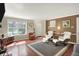 Open-concept living room features hardwood flooring, a window, and comfortable modern furnishings at 9243 Crossing Dr, Fishers, IN 46037