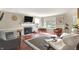 Bright living room features a fireplace, hardwood floors, with ample seating for relaxing and entertaining at 9243 Crossing Dr, Fishers, IN 46037