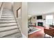 Inviting open-concept living space with hardwood floors, a fireplace, and staircase at 9243 Crossing Dr, Fishers, IN 46037