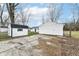 This backyard features a storage shed and concrete pad for parking or outdoor activities at 9923 N 125 W, Fortville, IN 46040