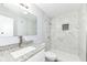 The renovated bathroom features a granite vanity and a shower with tiled walls at 9923 N 125 W, Fortville, IN 46040