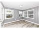 Charming bedroom featuring wood paneling, modern flooring and multiple windows for natural light at 9923 N 125 W, Fortville, IN 46040