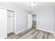 This bedroom features modern gray walls, a closet, and wood-look floors at 9923 N 125 W, Fortville, IN 46040