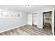 This bedroom features gray walls, wood-look floors, a closet, and a bright window at 9923 N 125 W, Fortville, IN 46040