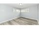 This bedroom features gray walls, wood-look floors, and two bright windows at 9923 N 125 W, Fortville, IN 46040