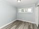 Cozy bedroom featuring gray walls, modern flooring, closet, and a large window at 9923 N 125 W, Fortville, IN 46040
