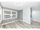 Bright dining room featuring wood paneling, modern flooring and a large window at 9923 N 125 W, Fortville, IN 46040