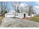 Charming single story home with detached garage, white siding, covered porch and gravel driveway at 9923 N 125 W, Fortville, IN 46040
