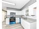 Modern kitchen with white cabinetry, granite countertops, stainless steel appliances and gray brick accent at 9923 N 125 W, Fortville, IN 46040