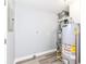 Utility room featuring water heater, laundry hookups, and updated flooring at 9923 N 125 W, Fortville, IN 46040