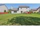 Beautiful backyard with lush lawn, mature trees, and a wood deck at 10576 Greenway Dr, Fishers, IN 46037