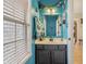 Bright blue bathroom with a window, a decorative mirror and a vanity at 10576 Greenway Dr, Fishers, IN 46037